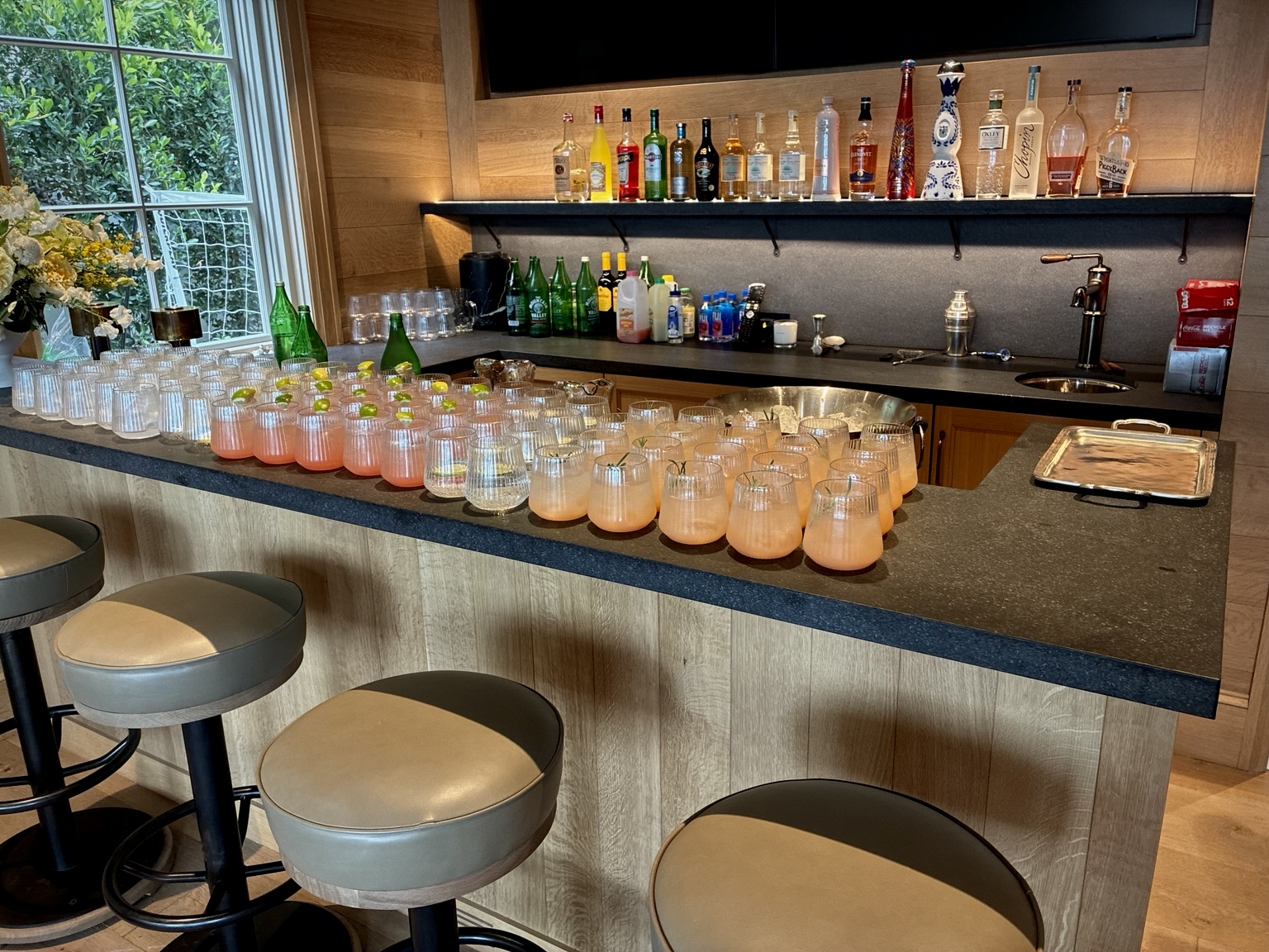 Cocktails and glassware prepared across a private residence bar